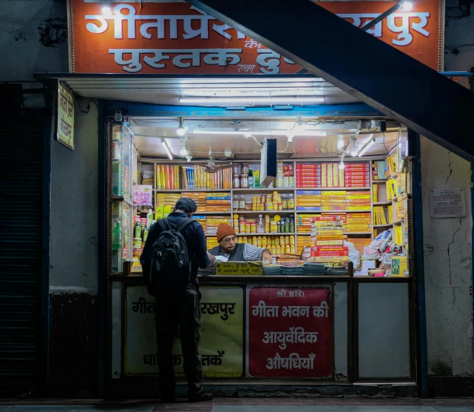 a man looking at books in the bookstore