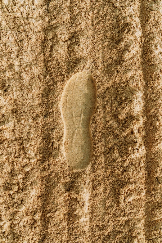 a person's footprints are seen on the sand