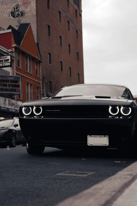 a car sitting on the street with a building in the background