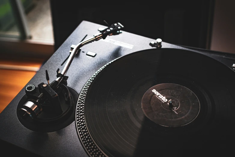 an old record player sitting on top of a wooden table