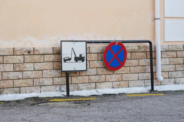 a brick wall with a blue and red sign on it