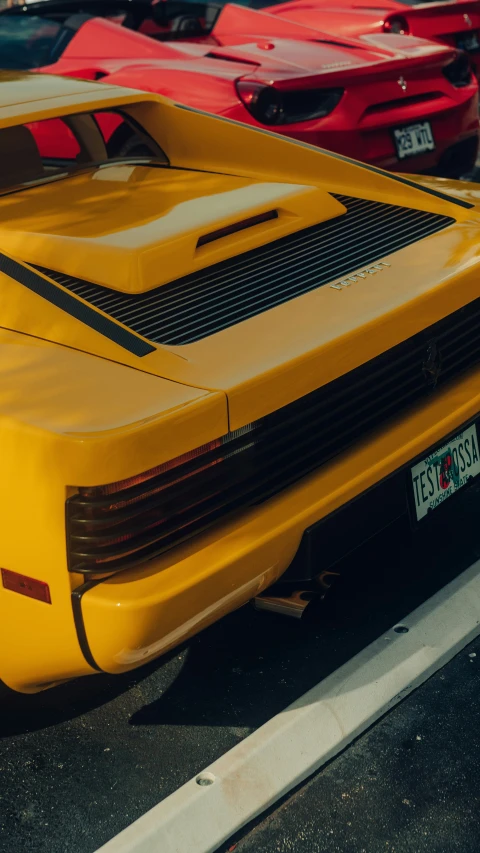 a yellow car parked in a parking lot near other cars