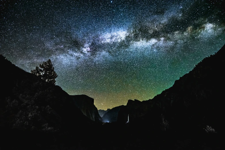 milky shines over a mountain valley with trees