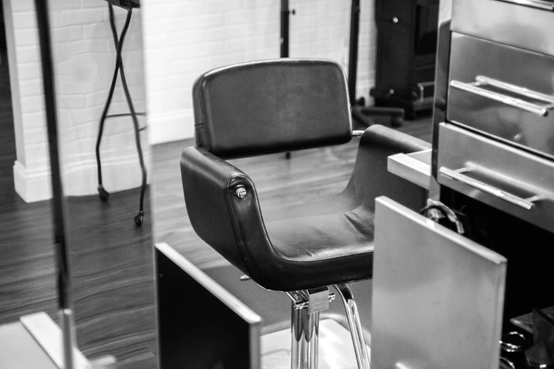 a black and white po of a stool in a barbershop