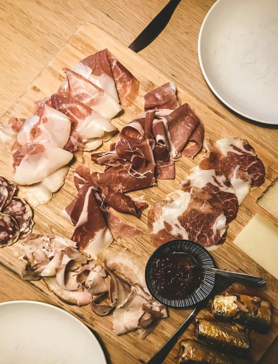 a  board topped with different kinds of meats