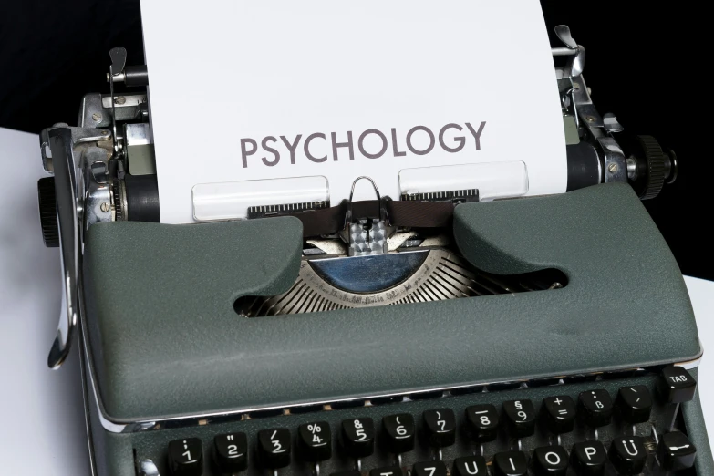 an old fashioned typewriter with a paper that says psychology
