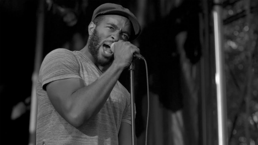 man in front of a microphone standing on stage