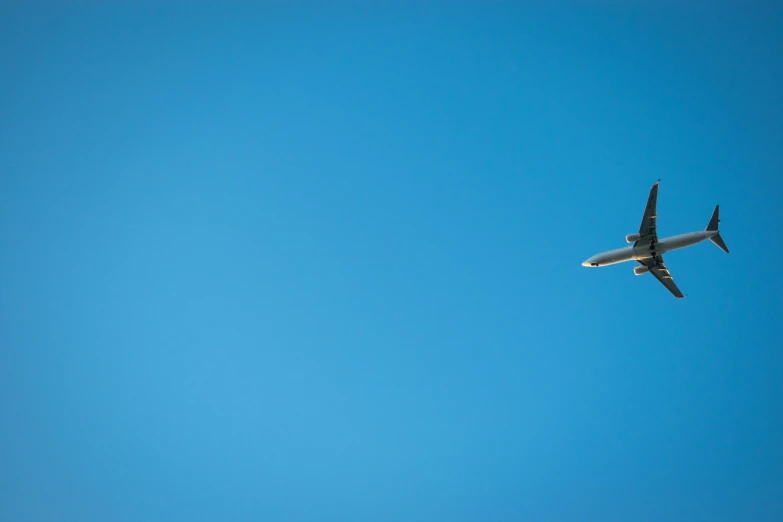 an airplane in the air with a blue sky behind it