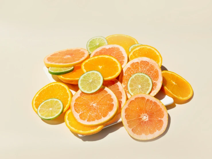 oranges and limes are displayed in this image