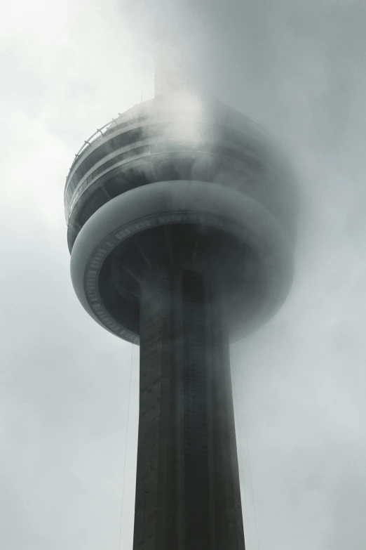 the sky line of this tower looks like it has steam from its ventilator