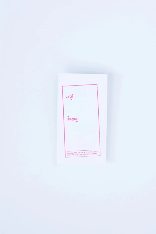 a single pink and white piece of paper with a tiny note attached
