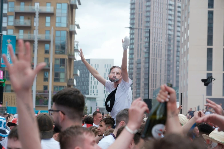 an image of a man holding his arms up