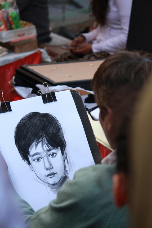 a drawing that is being held up by someone