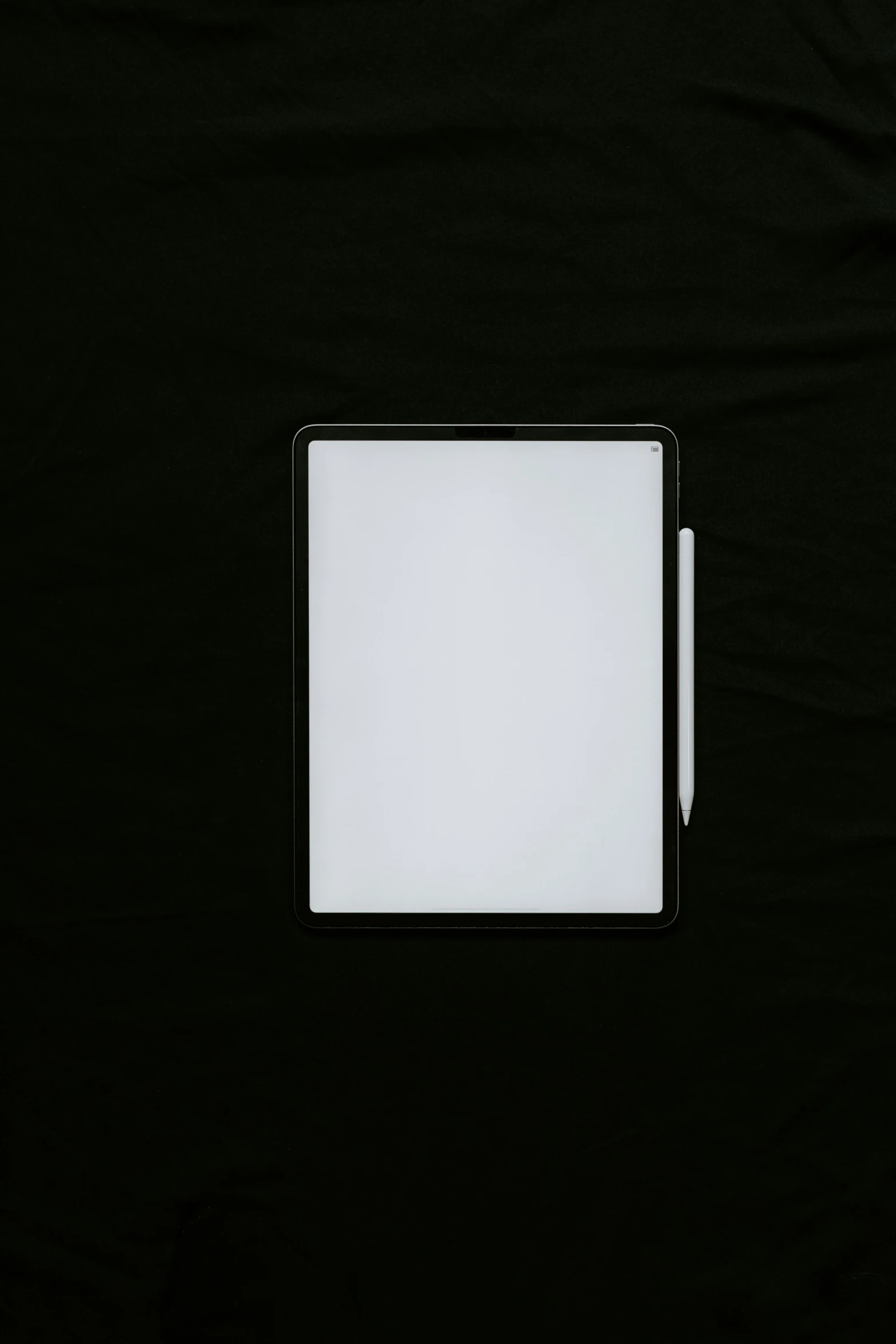 a pen and a paper on a black table