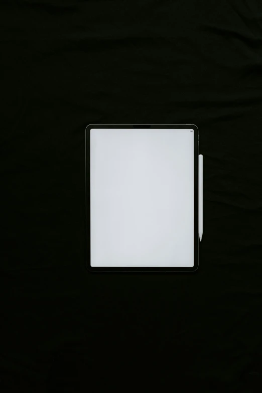 a pen and a paper on a black table