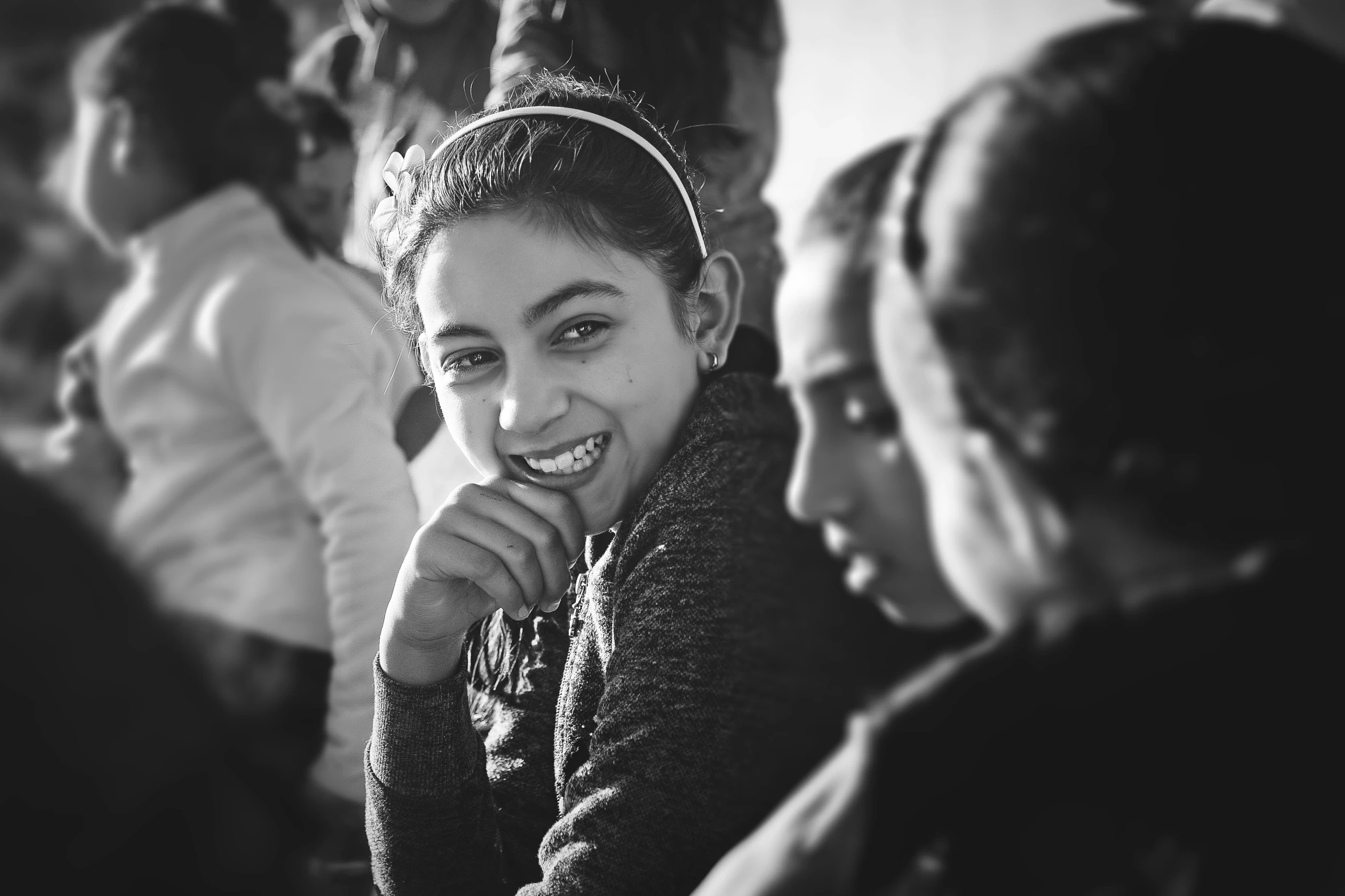 a woman smiles while her family looks on