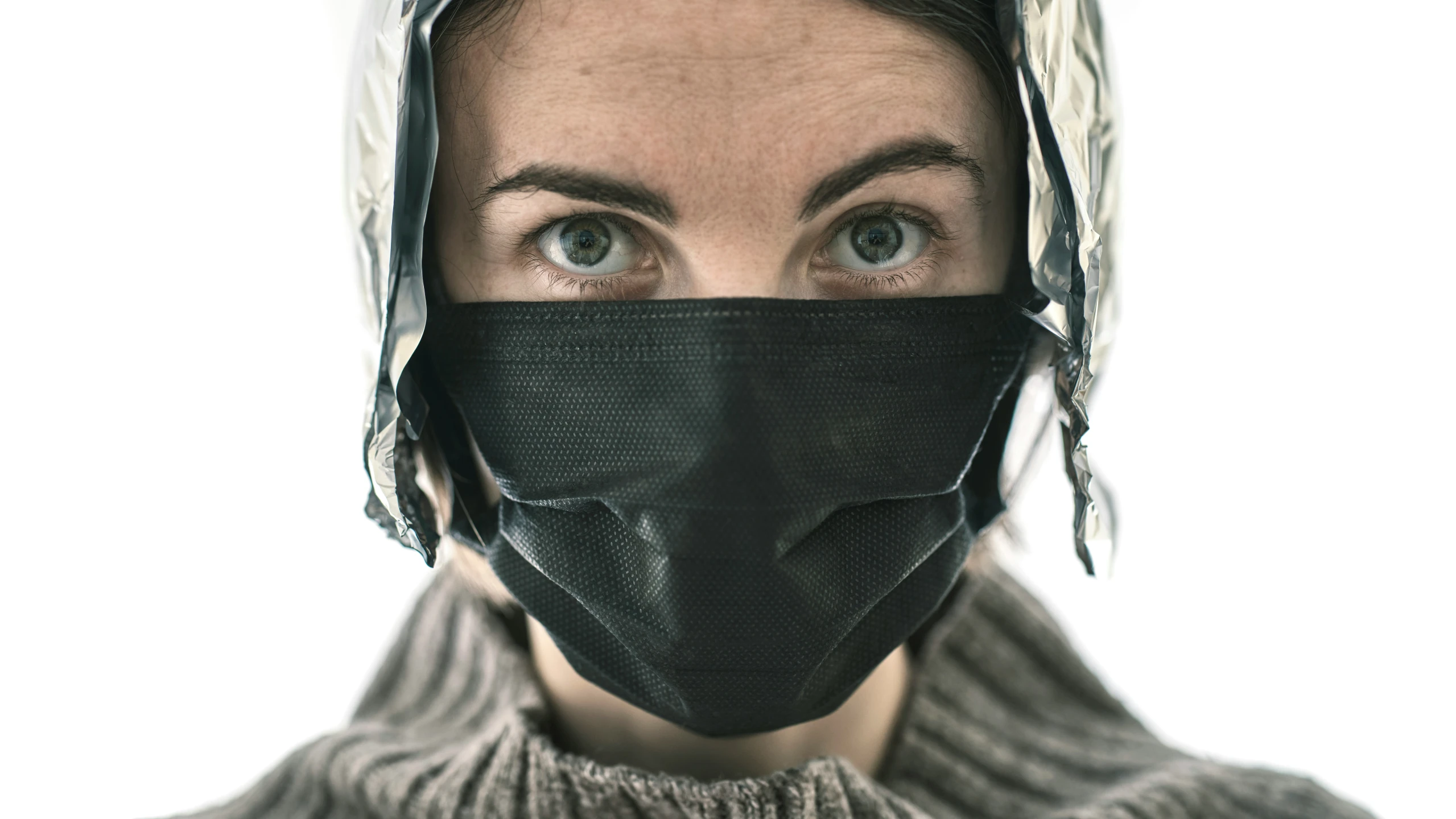 woman in black leather mask with feathers on her head