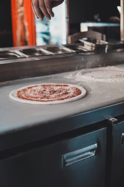 a person pulling soing off of an oven that is on the stove