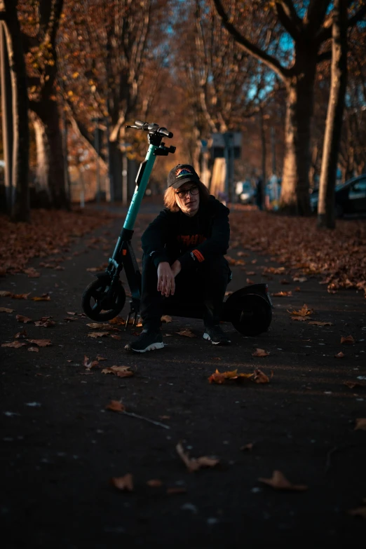 a person is kneeling down while with a bicycle