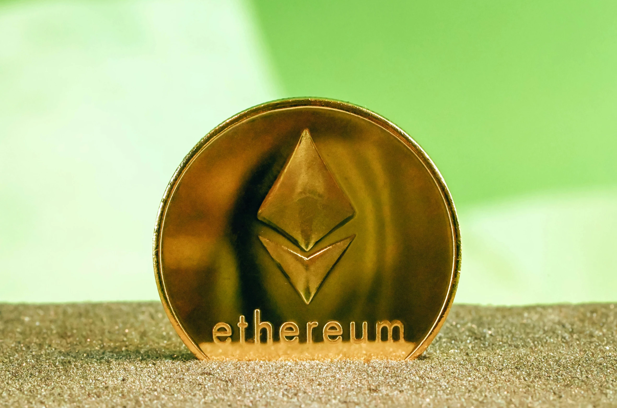 ethereum token on the floor in front of a green background