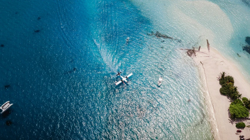 an aerial view of an airplane flying over the water