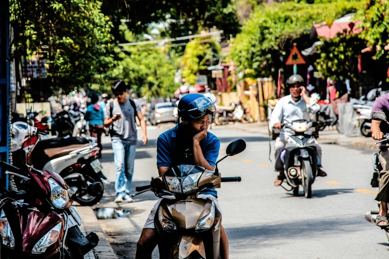 people riding motor bikes on a street