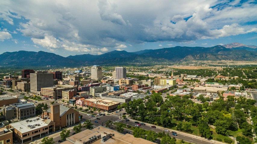 an aerial view of downtown with buildings and mountains in the background