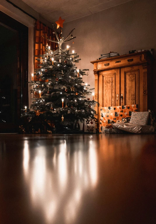 a small christmas tree with a presents in front of it