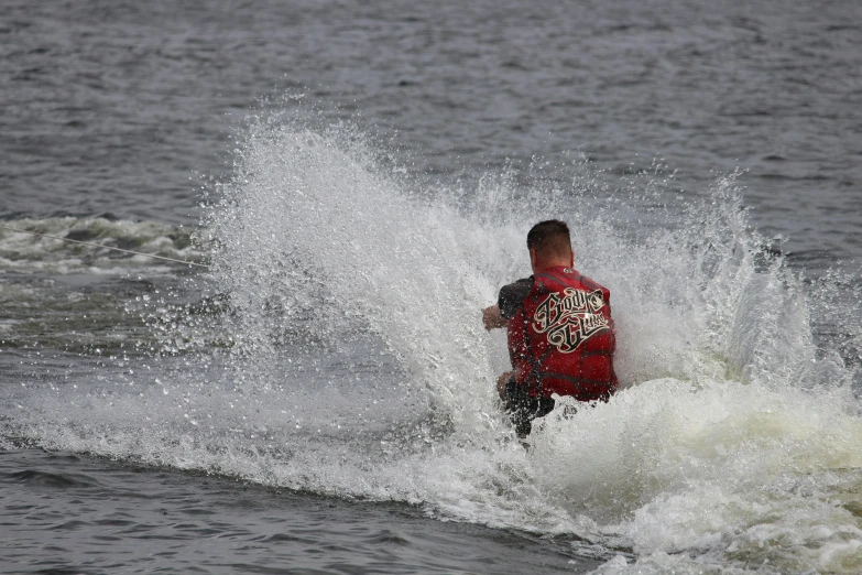 the man is surfing on a very small wave