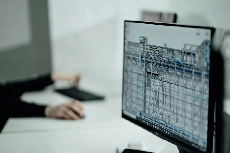 a person on a desk using a computer screen