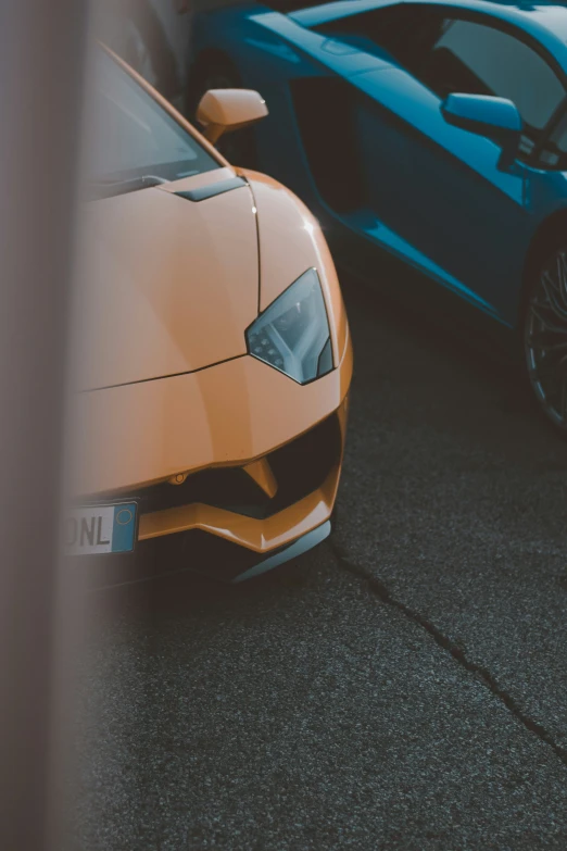 a brown sports car and a blue sports car