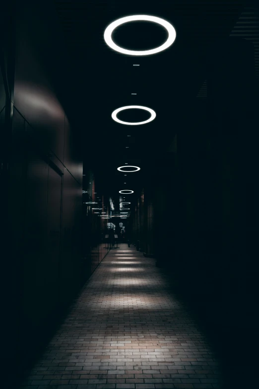 an alley way with many circular lights