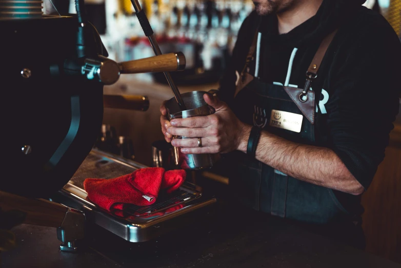 man in a hat is operating a beer keg