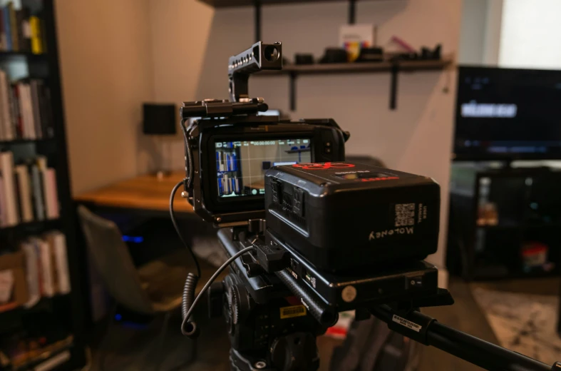 a camera is on a tripod in a room