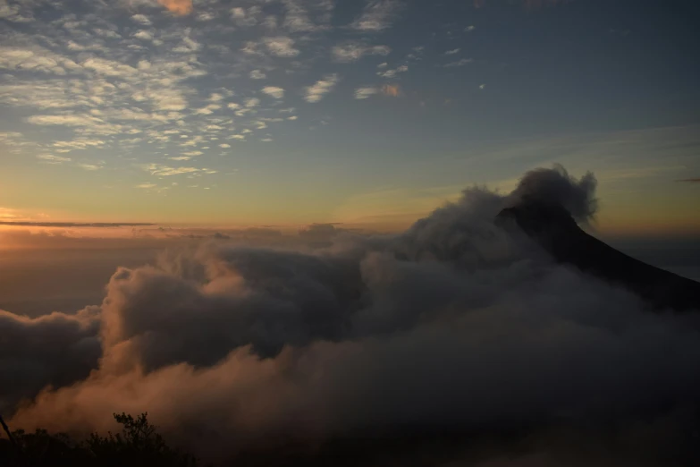 a view of clouds rolling into the valley