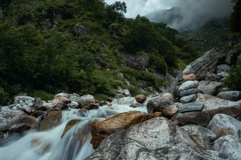 the rushing water flows down some rocks