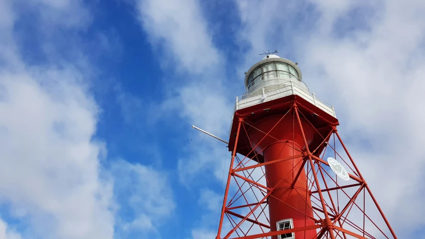 red tower with white top and blue sky