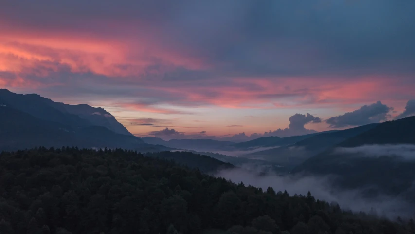 a hillside that has some mountains in the background