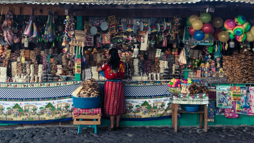 a woman in red standing outside of a shop