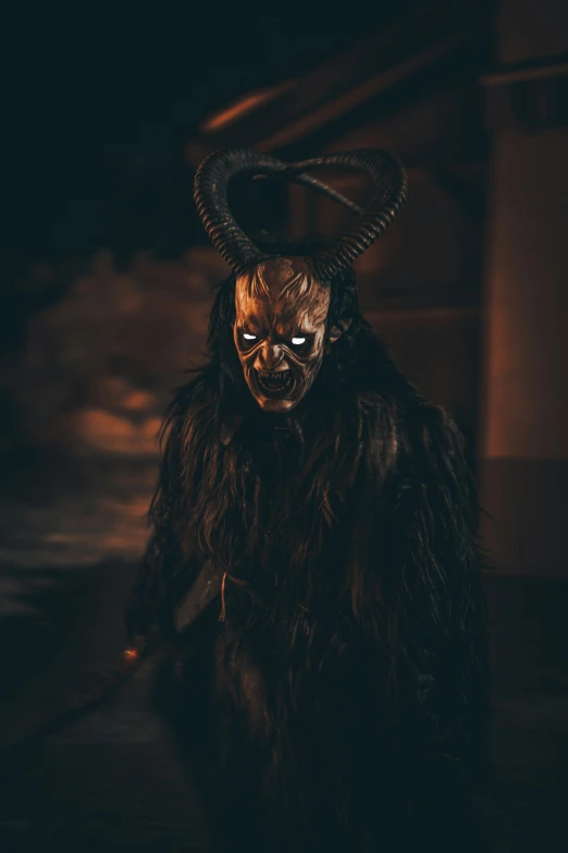 a man in devilish costume wearing a horned head