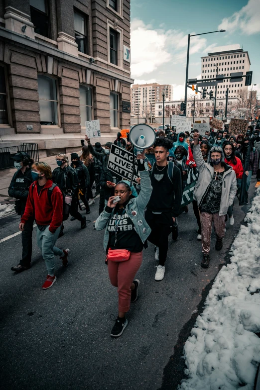 a protest with people walking in a street