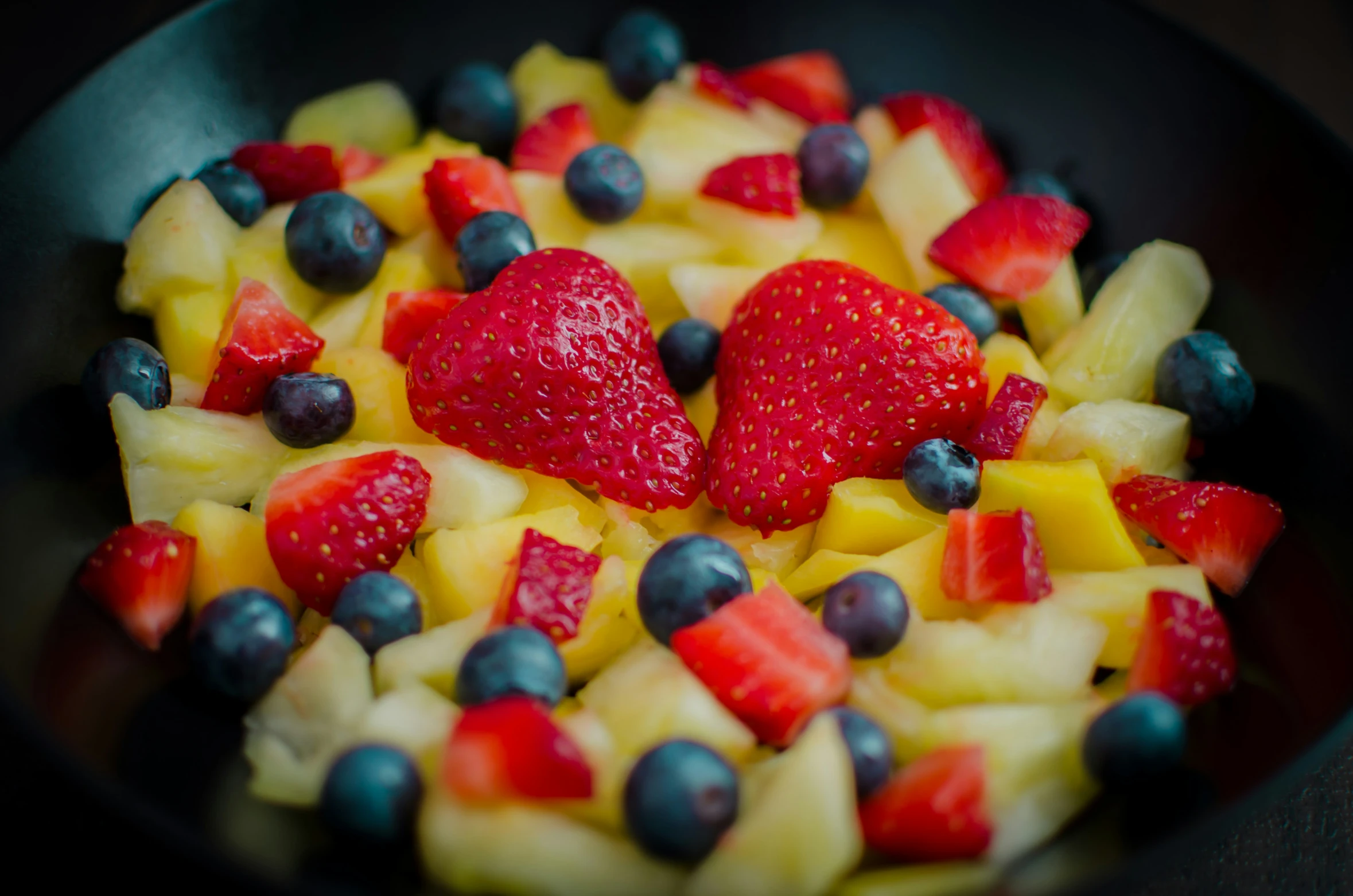 the plate is full of mixed fruit salad