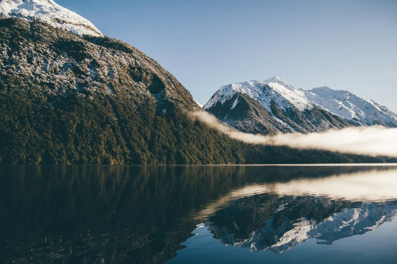 a mountain and the lake with low lying clouds