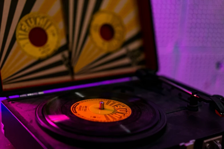 a record player with an empty cover and some colored lights