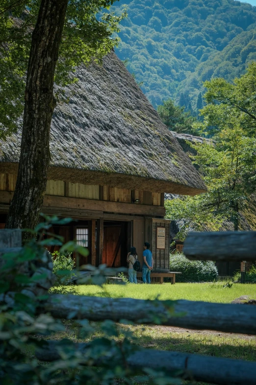 there are people that are walking in the yard of this house