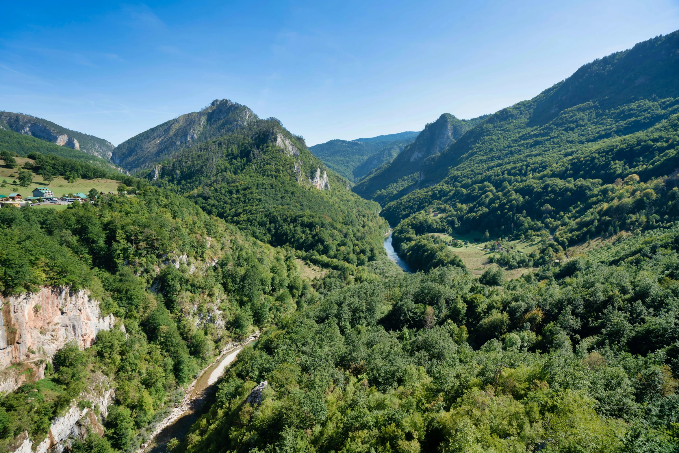 the scenic and tranquilly green river below a mountainous mountain valley