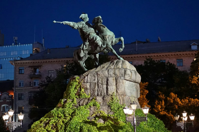 a statue of two men on horseback and a horse