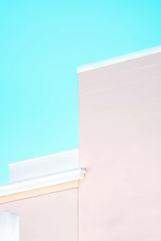 a bird flies over a building on a clear day