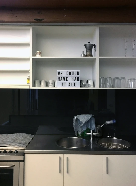 a kitchen with a black counter top next to a stove top oven