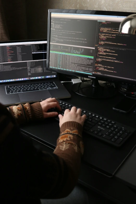 a person working at a computer on a table